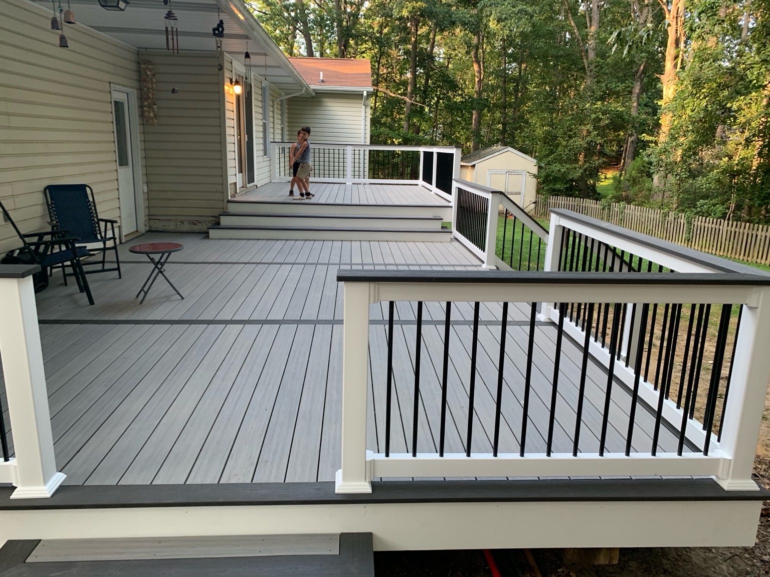 Gray composite deck with white posts and black balusters